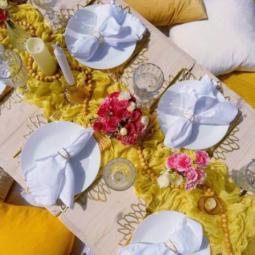 white napkins yellow table setting
