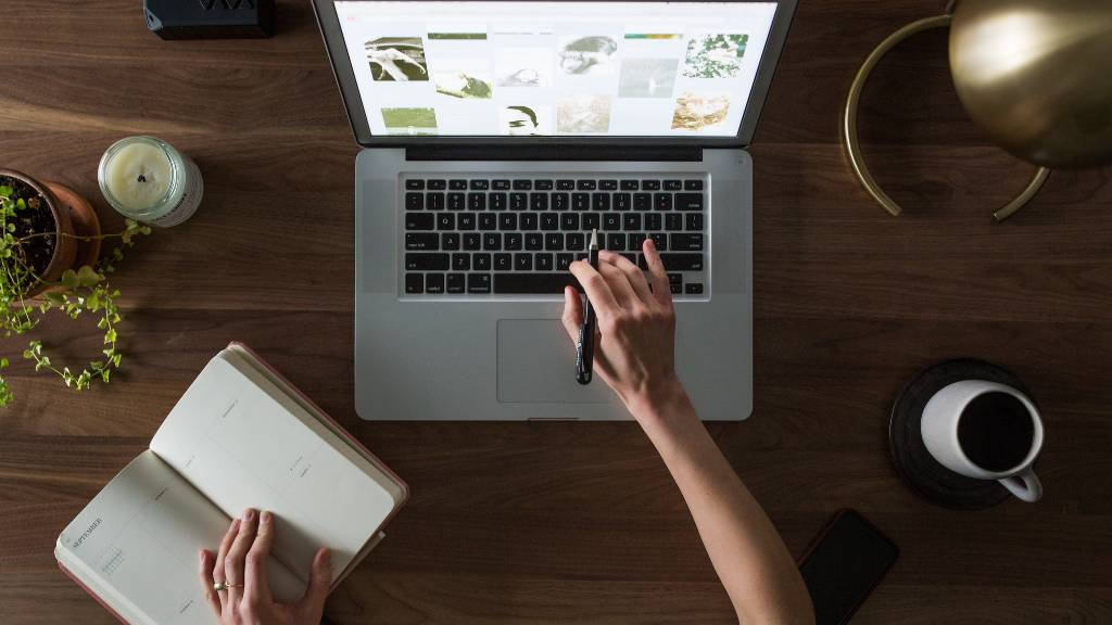 hands typing on laptop for event tasks