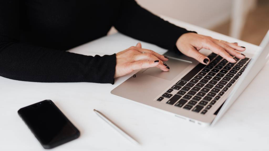 hands typing on laptop for events