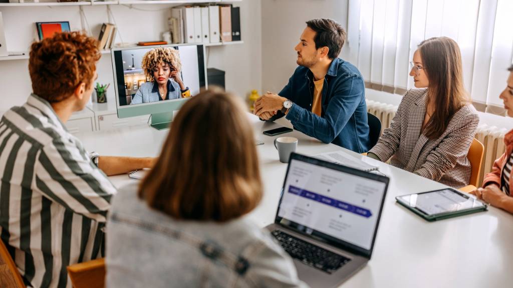 team attending hybrid meeting with online participant
