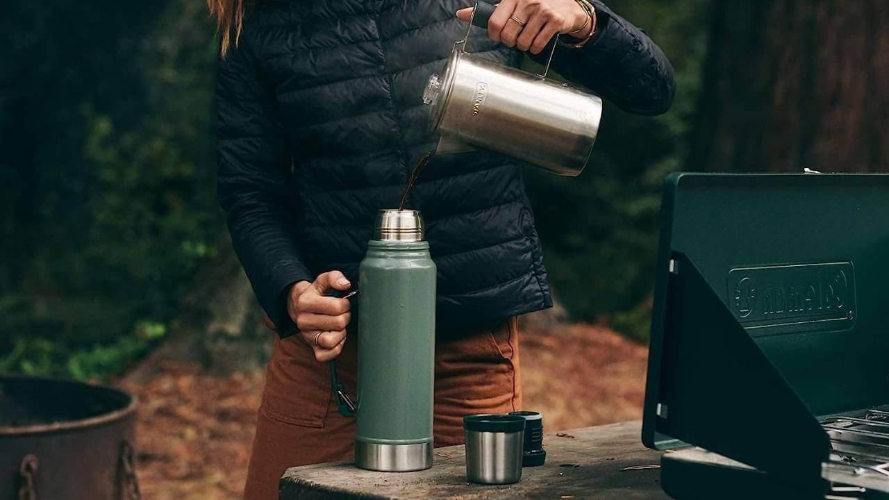 pouring coffee into stainless steel thermos